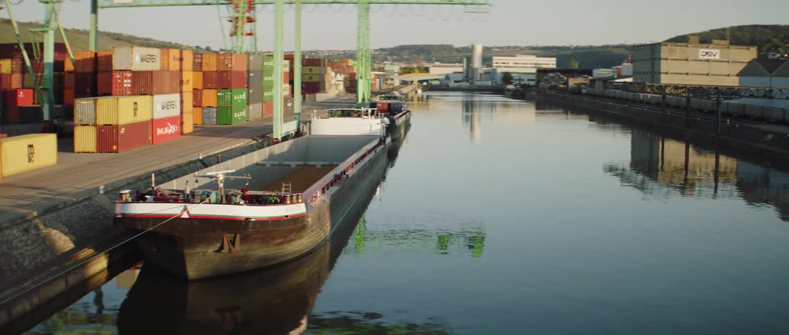 A shipping boat sits still in a shipping canal