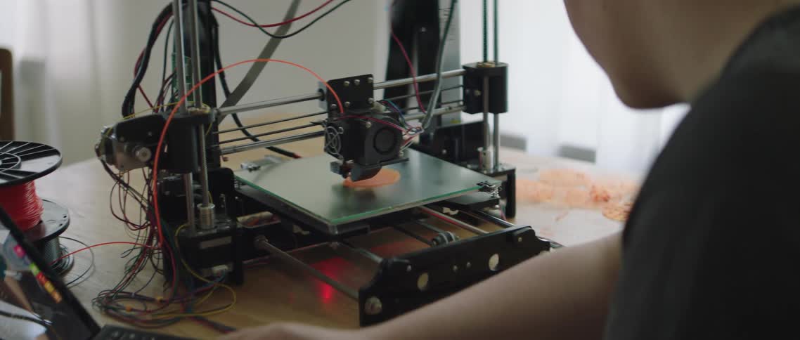 A white teenager messes around with a robotics experiment