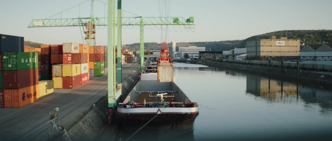 A container crane lifting a shipping container from a ship