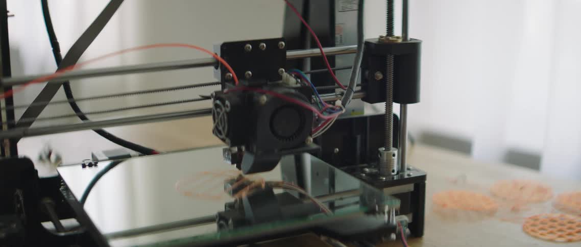 A man works with a 3d printer