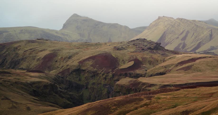 Clouds float above a hilly landscape