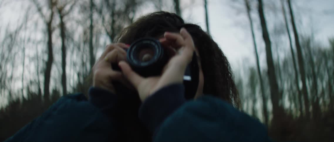A photographer takes pictures in a forest
