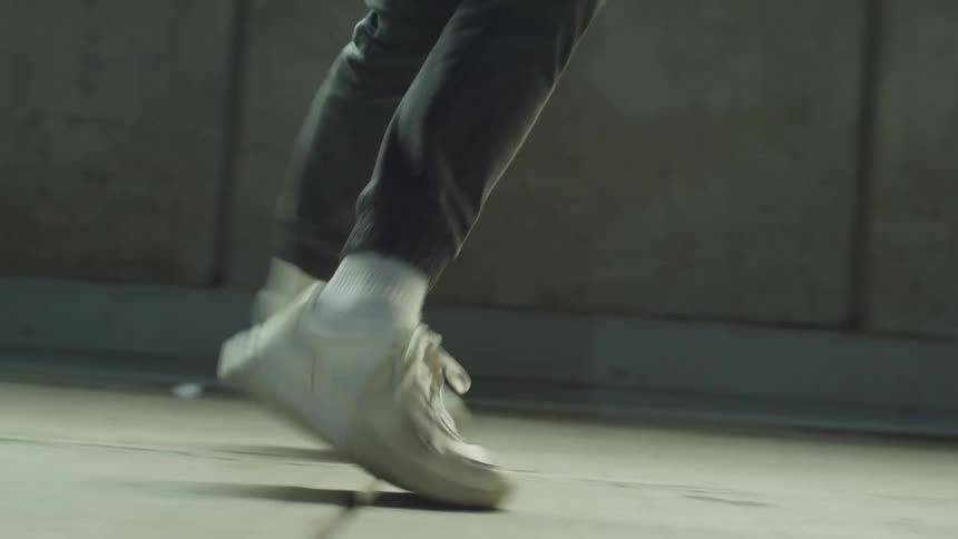 A person dances down a street