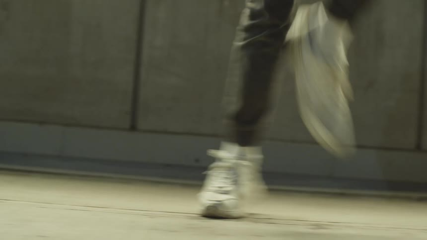 A street dancer dances down a street