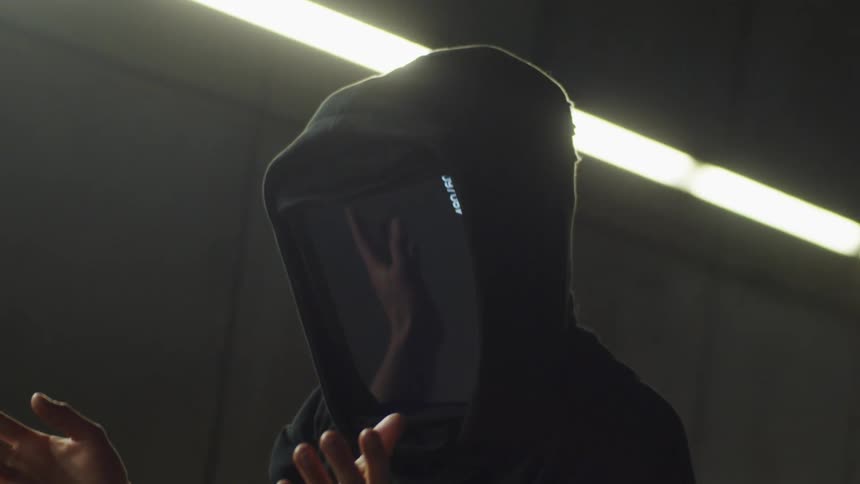 A dancer with a screen on his face