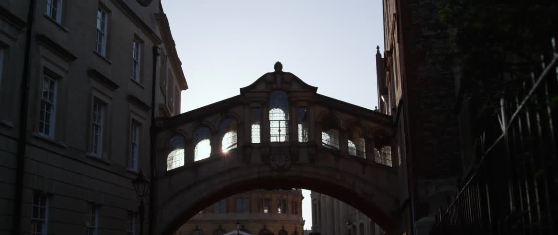 A person walks through Hertford Bridge arched passage way between two buildings