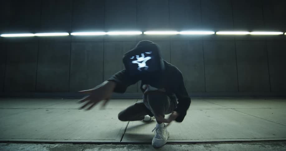 A dancer performs while wearing a digital display as a mask