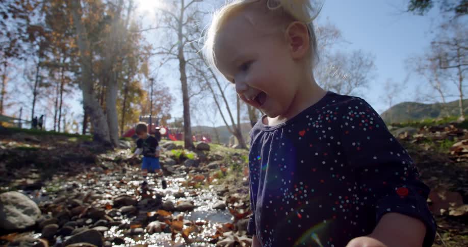 Children play in the small stream on the hill