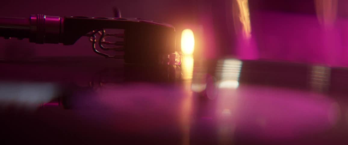 A light shines next to a rotating record on a record player