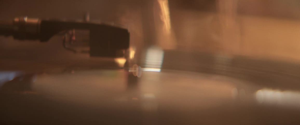 Smoke dissipates as a record player turns