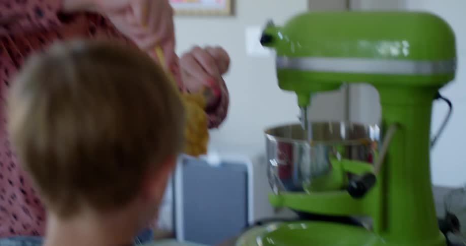 Mother and son baking cupcakes in kitchen