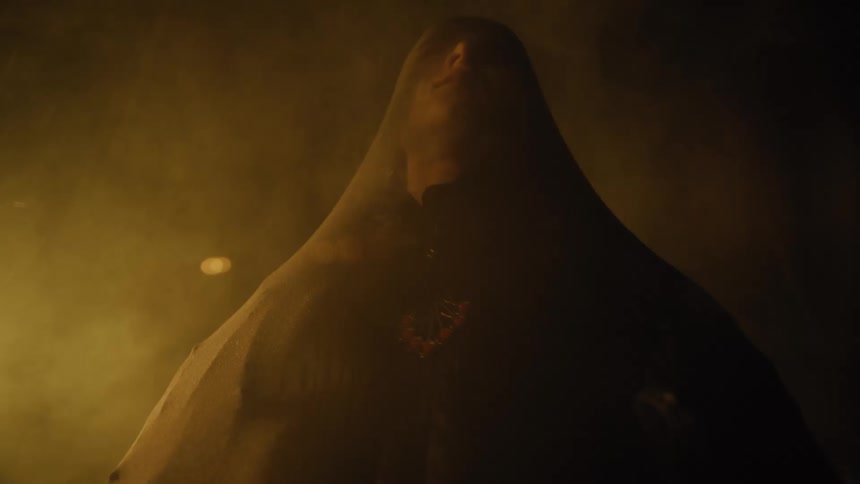 A man with his face covered with see through material rolls his head back