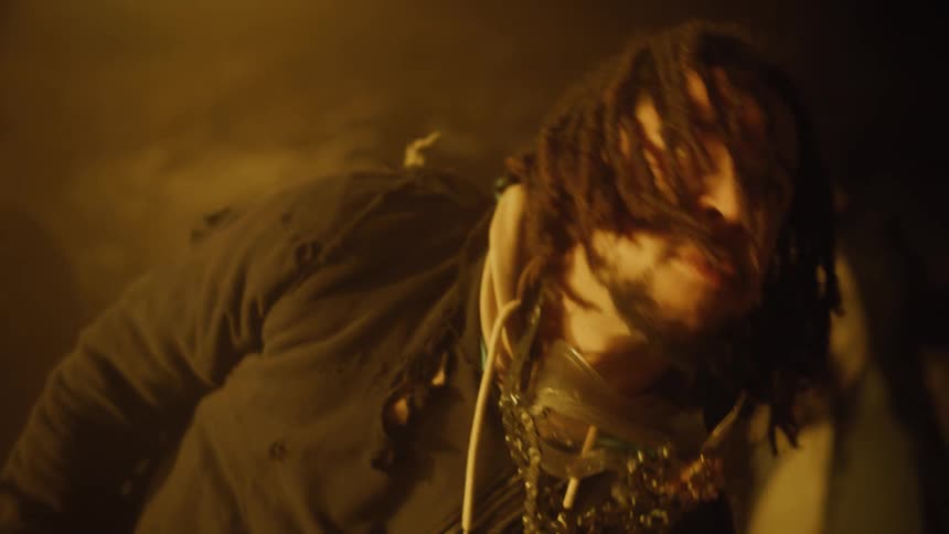 A black man with dreadlocks dances and acts weird in a club