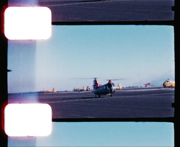 A chinook helicopter moves down a military bases tarmac