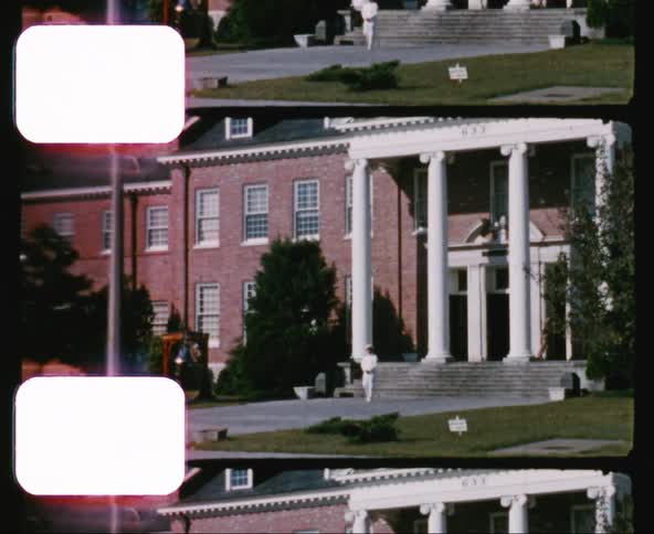 Vintage film reel of person in white uniform walking outside of government building