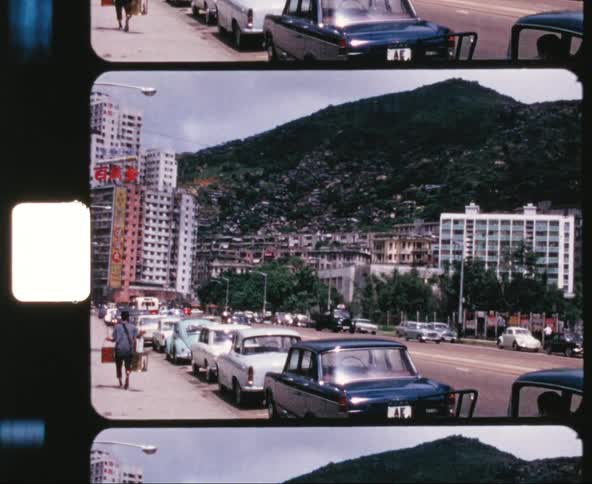 Traffic moves down a street in a downtown area of a city