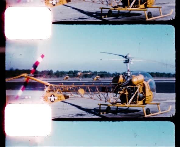 Military helicopters sit and take off at a military airstrip