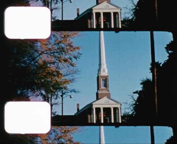 A steeple rises from a church rooftop