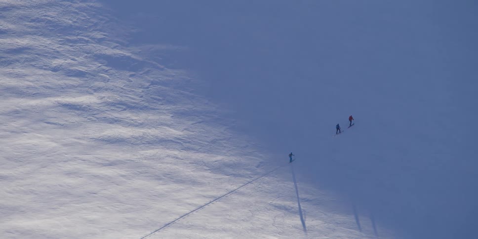 People walking up a snowy mountain