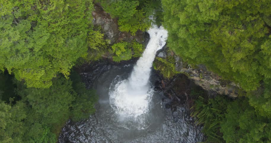Birds eye view of a waterfall crashing in to a river