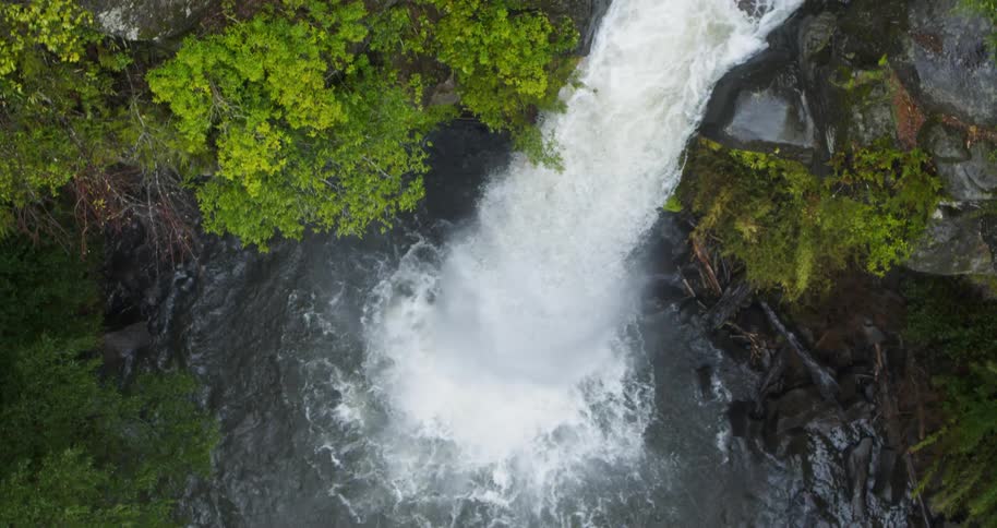 Aerial view of a cascading over tall cliff