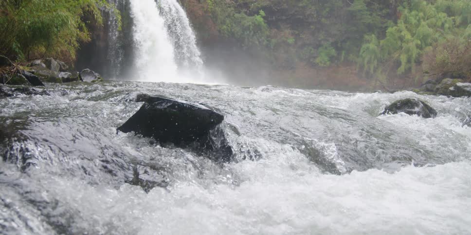 A waterfall crashes down in to the river