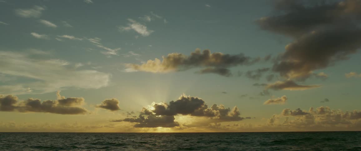 The low sun creating a two tone sky over the empty ocean