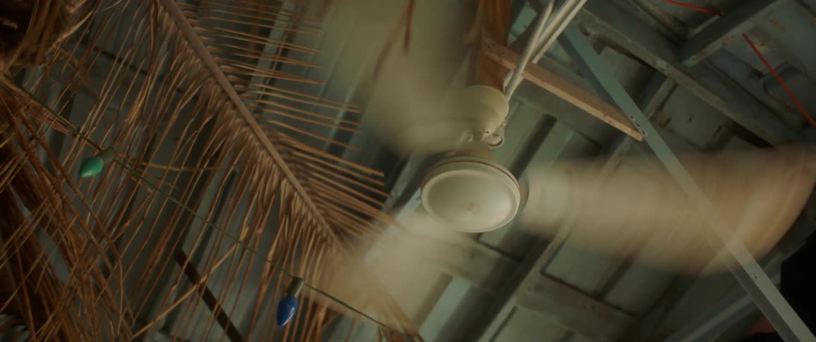 Ceiling fan spins rapidly as it hangs from the ceiling