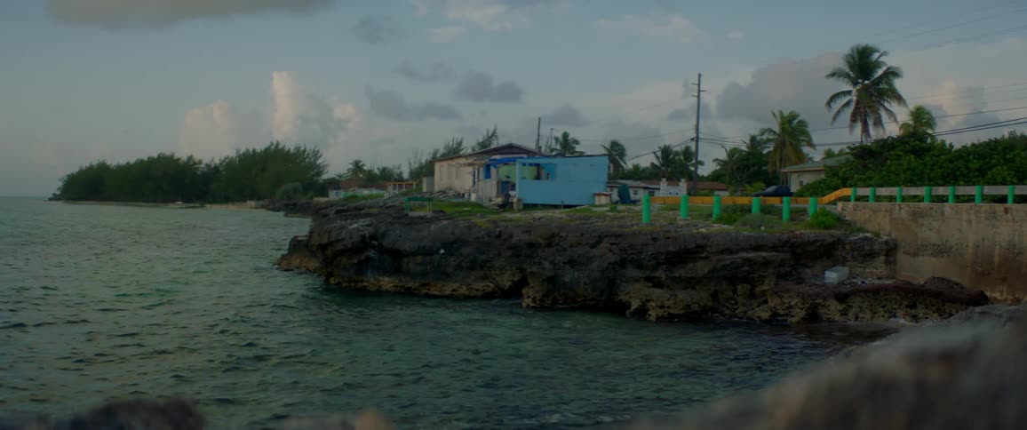 Small house sitting on rocky beach