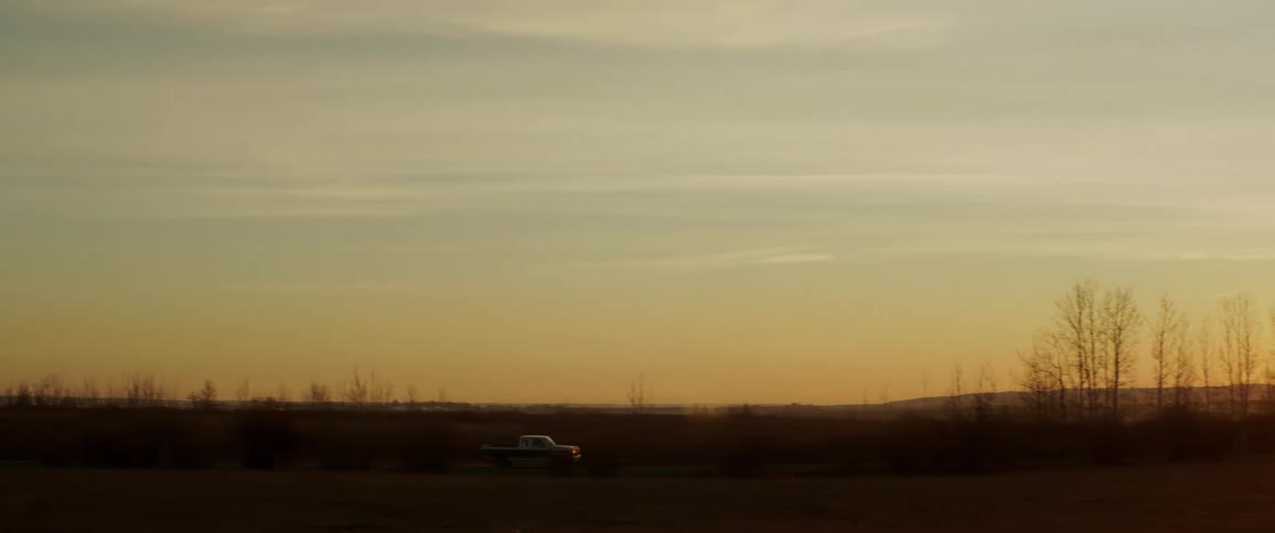 A truck drives across the landscape