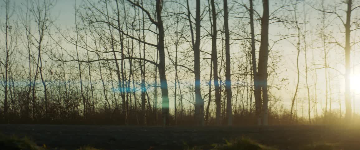 The sun sets as a truck drives past