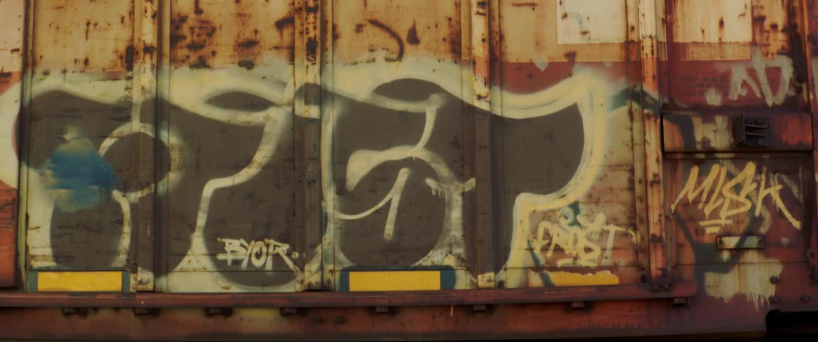 Graffiti words painted in various colors on freight container