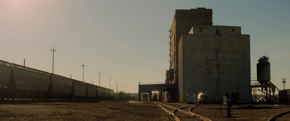 A train sits outside a factory