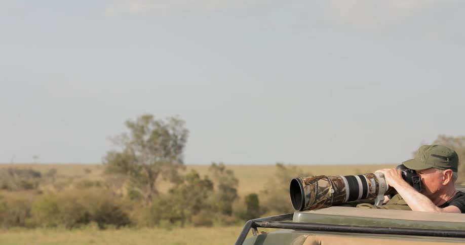 A photographer takes a photo on a safari