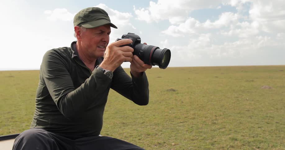 An elderly man taking photographs