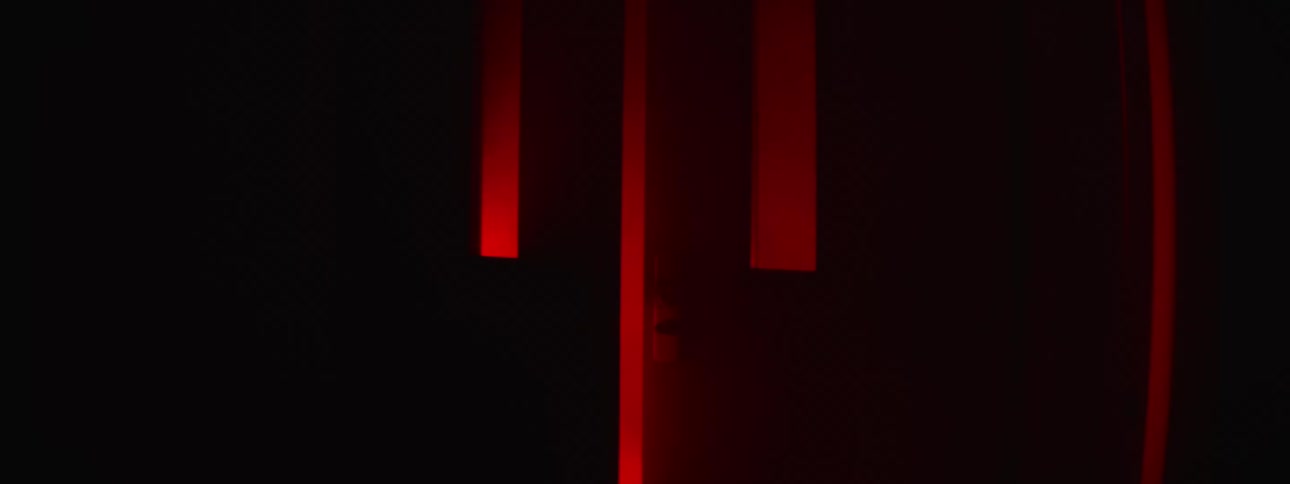 An outlet on a red board surrounded by two red beams