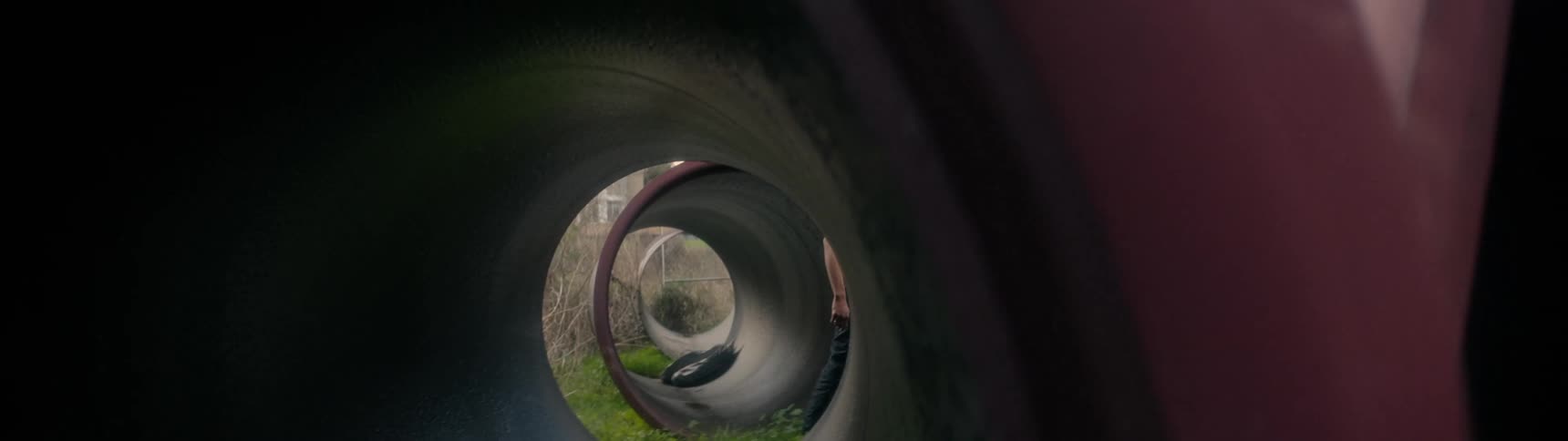 A man walks past large tunnels