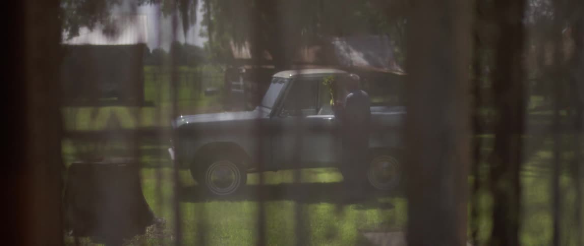 A man walking to his truck carrying something
