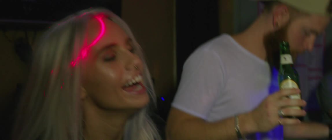 People dance at party near audio equipment