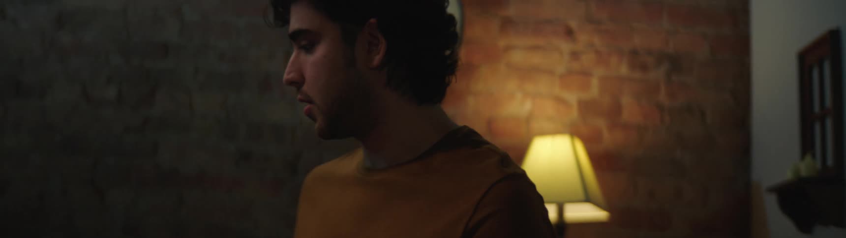 A man paces back and forth with an upset look on his face