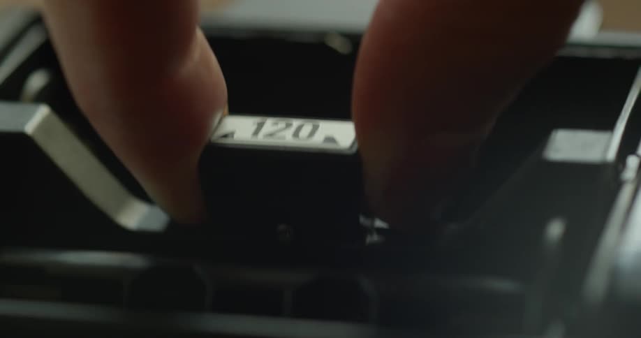 A person is grabbing film from a camera