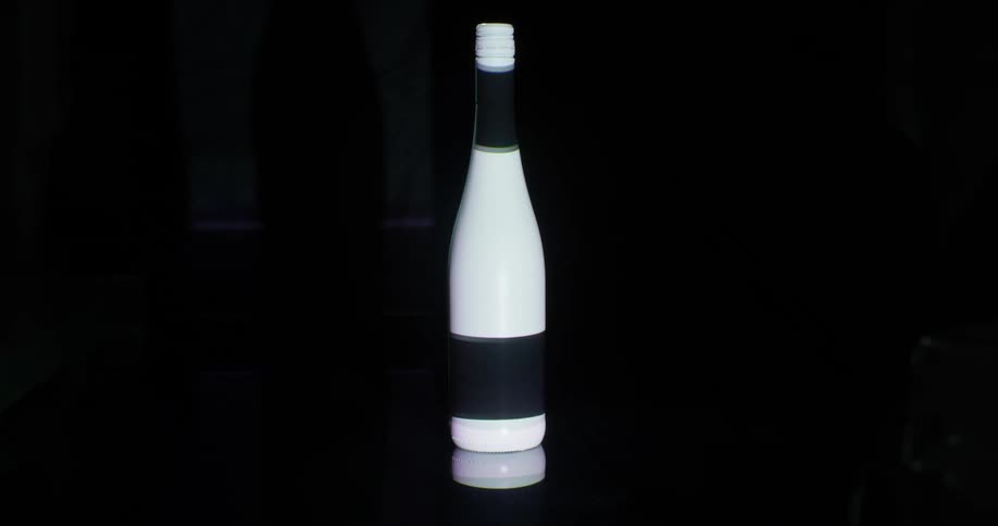 Light patterns projected on a dark wine bottle