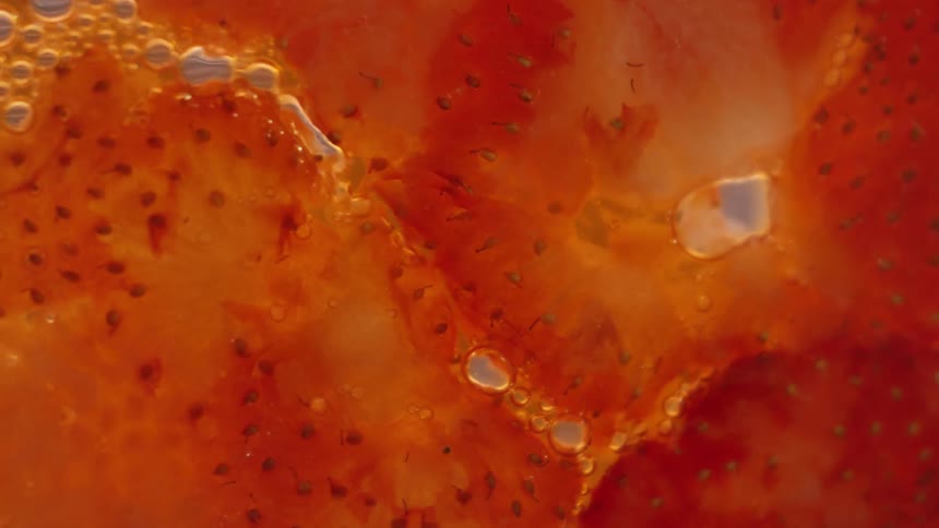 Liquid moving between cut strawberries