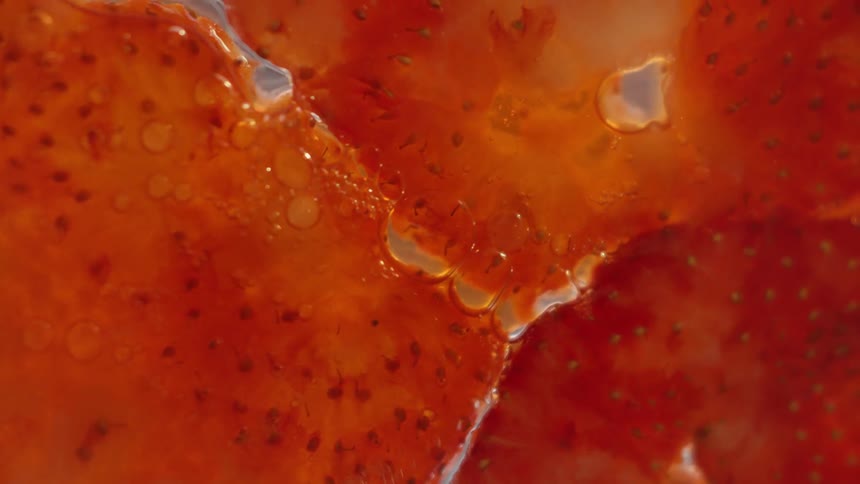 Liquid flows through sliced up strawberries