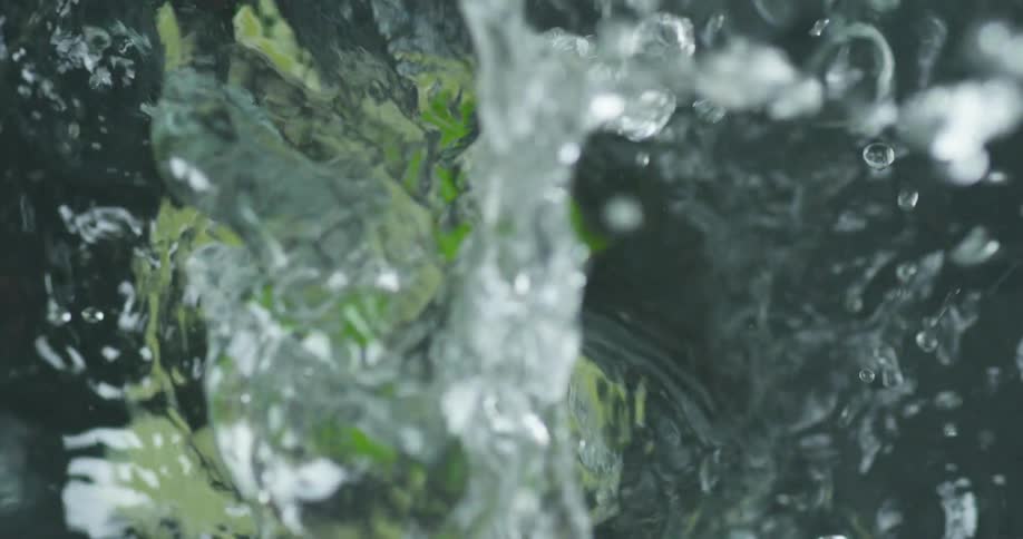Cut up limes falling in to water