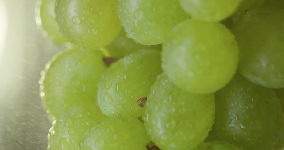 Grapes spinning while being sprayed with water