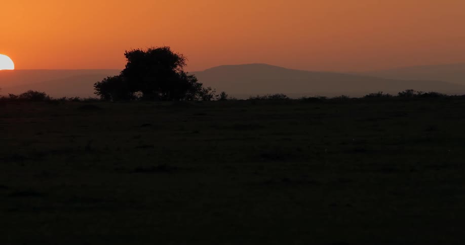 The sun sets over mountains