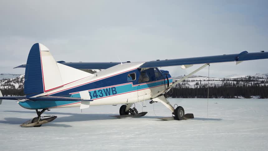 A plane is starting on the snow covered field
