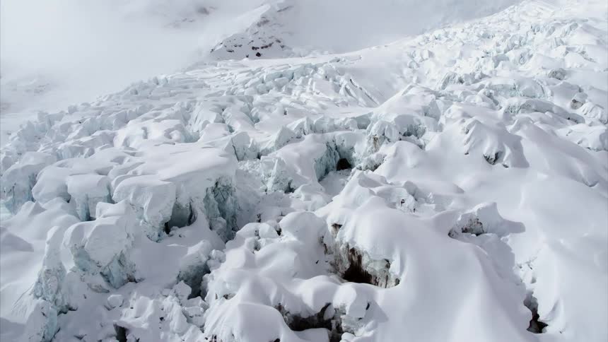 A jagged snow covered arctic landscape during the day