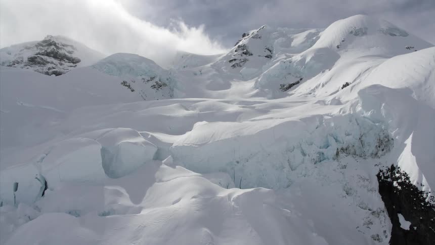 A mountain range covered in deep winter snow